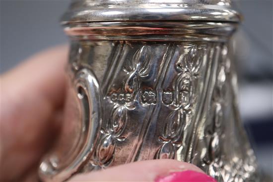 A pair of Edwardian repousse silver sugar casters, Sibray, Hall & Co, London, 1903/4, 20cm, 12.5 oz.